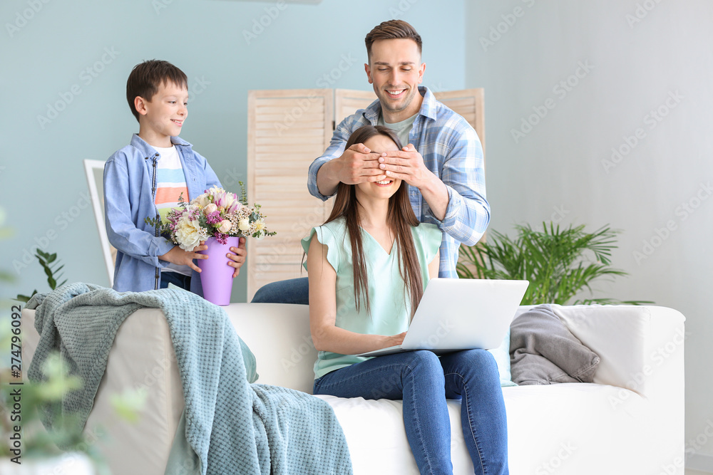 Family greeting young woman at home