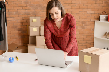 Female owner of online shopping site preparing order for client