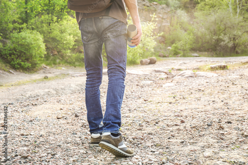 Male tourist near forest on spring day