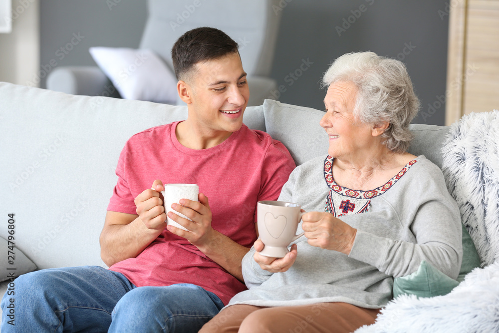 Senior woman with her grandson resting at home
