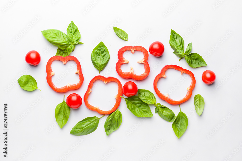 Fresh basil, tomato and pepper on light background