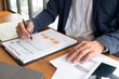 © ntinai - Businessmen, finance, accounting work, checking accounts, using calculators and finding information