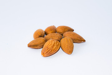 close up of  brown almonds seeds isolated on white background