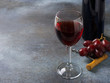 © Denira - Bottle of red wine with glasses with drink and grapes on dark background