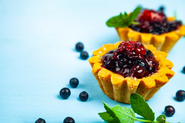 Small berry cake and ripe berries