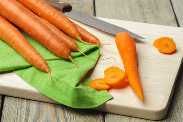 Wall Mural - chopping healthy carrots on slice on chopping board in the kitchen