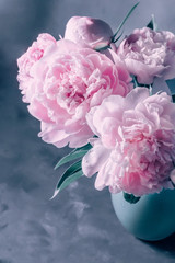 Bouquet of pink peonies in a vase in pastel colors soft focus