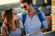 © NDABCREATIVITY - Young couple travelling with a map in the city
