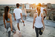 © NDABCREATIVITY - Group of happy fit friends exercising outdoor in city
