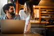 © NDABCREATIVITY - Portrait of a cheerful couple shopping online with laptop