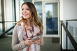 © NDABCREATIVITY - Outdoors portrait of beautiful young girl laughing and using cell phone