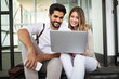 © NDABCREATIVITY - Couple have fun while looking on laptop at cafe