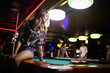 © NDABCREATIVITY - Young happy girl having fun with billiard. Play and fun concept.