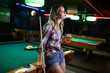 © NDABCREATIVITY - Young beautiful girl is playing billiards. Pleasant pastime, rest, entertainment.
