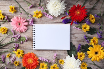 Wall Mural - Colorful chrysanthemums placed on the table old wooden with book diary for text