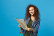 Young african american girl teen student in denim clothes, backpack hold map isolated on blue wall background studio portrait. Education in high school university college concept. Mock up copy space.