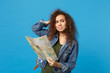 © ViDi Studio - Young african american girl teen student in denim clothes, backpack hold map isolated on blue wall background studio portrait. Education in high school university college concept. Mock up copy space.