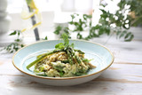 Fototapeta Londyn - Risotto with spinach and green asparagus. Appetizing dish