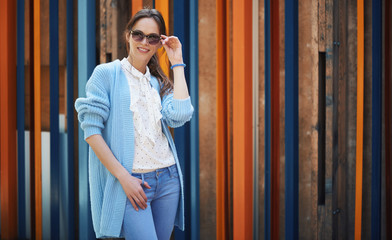 Wall Mural - Outdoors portrait of a stylish woman in sunglasses