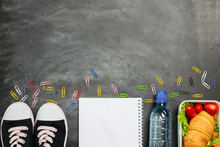 Sandwich Training Supplies Notebook Pens Colored Pencils Clip Sneakers On Chalk Board. Concept Back To School. Top View