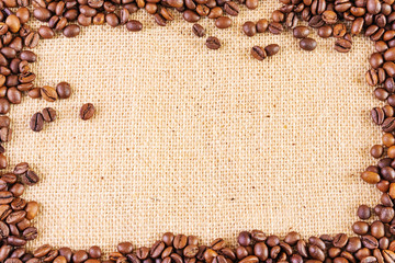 Frame of coffee beans on a background of burlap. Place for text. Concept of making coffee, coffees. Top view, minimalism, flat lay. Warm brown and beige shades.