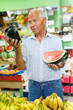 © JackF - Man choosing fruits in market