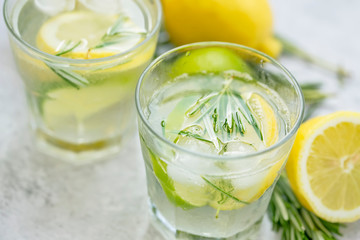 Lime, lemon , rosemary lemonade with ice cubes, refreshing summer drink