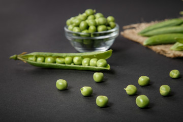 Closeup of green fresh peas and pea pods. Healthy food.