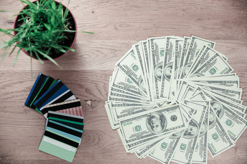 close up.credit cards and dollar bills laid out on a wooden table