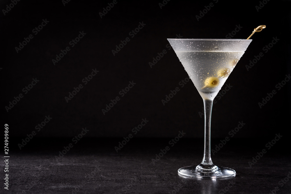 Classic Dry Martini with olives on black background. Copyspace - obrazy, fototapety, plakaty 