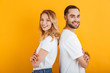 © Drobot Dean - Image of caucasian people man and woman in basic t-shirts smiling while standing back to back