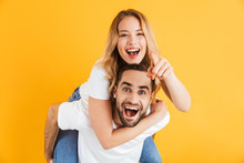 Image Of Excited Couple Laughing And Having Fun While Handsome Guy Piggybacking Pretty Woman