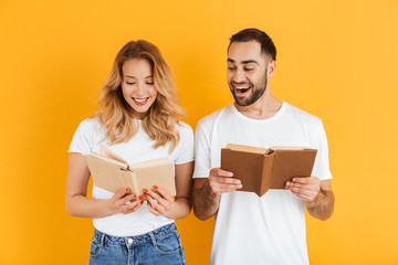 Image of attractive couple man and woman expressing interest while reading books together