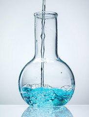 Wall Mural - different laboratory glassware with liquid and with reflection