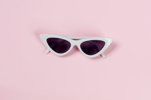 White Glasses Of Unusual Trend Shape On A Pink
