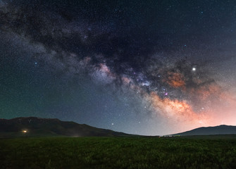 The green field and milky way galaxy. Beautiful starry night.  Space background.