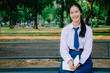 © TeTe Song - A shot of a girl college student sitting reading book on a bench in the park
