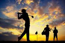 Golf Players At Sunset