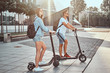 © Fxquadro - Young attractive couple is enjoying nice summer day while riding their own electro scooters.