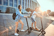 © Fxquadro - Young attractive couple is enjoying nice summer day while riding their own electro scooters.