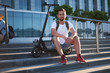 © Fxquadro - Pensive attractive man is sitting on the stairs with his electric scooter at bright sunny day.