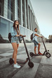 © Fxquadro - Young attractive couple is enjoying nice summer day while riding their own electro scooters.