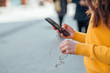 © bnenin - Casual girl using phone, close-up, copy space.
