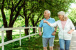 © LIGHTFIELD STUDIOS - retired woman with grey hair pointing with finger near surprised husband