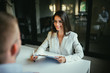 © bnenin - Young positive female job interview recruiter on a meeting with a candidate.