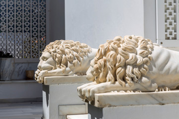 Sculpture of two marble lions lying at the entrance (Andros Island, Cyclades, Greece)