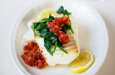 Wall Mural - Cod fillet with spinach and tomato salsa