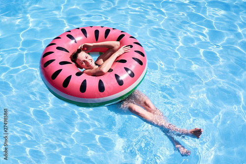 Woman With Short Hair Swimming Relaxing In A Pool With Pink
