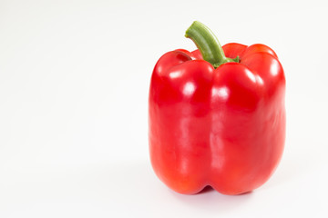 Wall Mural - Red Bell Pepper with stem on a white background.