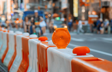 Roadblock or construction site lock with signal on a road. Red and white street barricade.